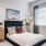 spacious, carpeted bedroom with large windows